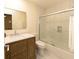 Bright bathroom featuring a wood vanity, large mirror, and tiled shower with glass door at 780 Wilson Terrace Ct, Carmel, IN 46032