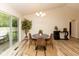 Cozy dining area featuring a modern chandelier, round table, and sliding door to the backyard at 780 Wilson Terrace Ct, Carmel, IN 46032