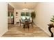 Bright dining area with backyard views, wood-look floors, and modern light fixture at 780 Wilson Terrace Ct, Carmel, IN 46032