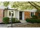 Home exterior boasts a cozy front porch with brick detail, decorative lamp, and manicured landscaping at 780 Wilson Terrace Ct, Carmel, IN 46032