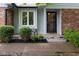 Charming front porch with room for seating, enhanced by manicured landscaping and stylish brick accents at 780 Wilson Terrace Ct, Carmel, IN 46032
