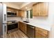 Updated kitchen boasts stainless steel appliances, wood cabinets, and bright white countertops with a window view at 780 Wilson Terrace Ct, Carmel, IN 46032