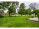 Expansive backyard featuring a fire pit, shed, and lush green grass perfect for outdoor activities at 8103 Rumford Rd, Indianapolis, IN 46219