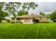 A sprawling backyard with a well-maintained lawn and a brick home at 8103 Rumford Rd, Indianapolis, IN 46219