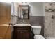 Traditional bathroom featuring a vanity with a granite countertop, decorative mirror, and tiled shower at 8103 Rumford Rd, Indianapolis, IN 46219