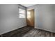 Simple bedroom with hardwood floors, a window, and closet with bi-fold doors at 8103 Rumford Rd, Indianapolis, IN 46219