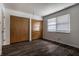 Spacious bedroom with hardwood floors, closet with bi-fold doors, and a bright window at 8103 Rumford Rd, Indianapolis, IN 46219