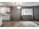 Bright kitchen with white cabinets, laminate counters, and a large window overlooking the yard at 8103 Rumford Rd, Indianapolis, IN 46219