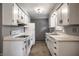 Galley kitchen with white cabinets and appliances offering ample counter space at 8103 Rumford Rd, Indianapolis, IN 46219