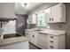Clean kitchen featuring white cabinets and modern appliances, including a dishwasher and range at 8103 Rumford Rd, Indianapolis, IN 46219