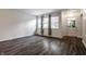 Bright living room with hardwood flooring, neutral walls, and natural light streaming through large windows at 8103 Rumford Rd, Indianapolis, IN 46219