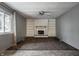 Bright living room with a fireplace, built-in shelving, and a ceiling fan at 8103 Rumford Rd, Indianapolis, IN 46219