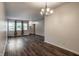Open concept living room featuring sleek hardwood floors, large windows, and an adjacent dining area at 8103 Rumford Rd, Indianapolis, IN 46219