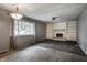 Spacious living room with a fireplace, built-in shelving, and large windows that provide natural light at 8103 Rumford Rd, Indianapolis, IN 46219
