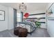 Cozy bedroom with striking modern fixtures, patterned accent wall, and ample natural light at 8384 Leander Ave, Zionsville, IN 46077
