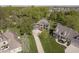 Stunning aerial view of a beautiful two-story home with lush green lawns and mature trees, surrounded by a welcoming neighborhood at 839 Pebble Brook Pl, Noblesville, IN 46062