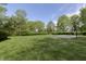 Expansive backyard featuring well-manicured lawn and mature trees at 839 Pebble Brook Pl, Noblesville, IN 46062