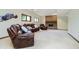 Basement living area with comfortable leather furniture and a brick fireplace at 839 Pebble Brook Pl, Noblesville, IN 46062