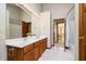 Bright bathroom with double vanity, framed mirrors, and wood cabinets at 839 Pebble Brook Pl, Noblesville, IN 46062