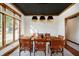 Modern dining room with dark ceiling, wood table, and large window showcasing natural light at 839 Pebble Brook Pl, Noblesville, IN 46062