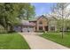 Lovely two-story red brick home with a gray roof and a long driveway at 839 Pebble Brook Pl, Noblesville, IN 46062