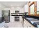 Kitchen featuring white cabinets, stainless steel appliances and dark countertops at 839 Pebble Brook Pl, Noblesville, IN 46062
