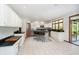 Open kitchen with white cabinets, a large island, stainless appliances, and views to the outside at 839 Pebble Brook Pl, Noblesville, IN 46062