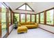 Bright sunroom featuring large windows, tiled floors, and a comfortable yellow couch at 839 Pebble Brook Pl, Noblesville, IN 46062