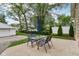 A nice backyard offers a concrete patio and a table with chairs, perfect for relaxation at 944 N Harbison Ave, Indianapolis, IN 46219