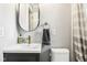 Bright bathroom featuring a modern vanity with gold accents and updated fixtures at 944 N Harbison Ave, Indianapolis, IN 46219
