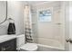 Bright bathroom featuring a shower over tub with modern fixtures and plenty of natural light at 944 N Harbison Ave, Indianapolis, IN 46219