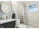 Bright bathroom featuring a modern vanity, updated fixtures and a shower over tub at 944 N Harbison Ave, Indianapolis, IN 46219