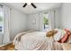 Cozy bedroom with warm, neutral tones, hardwood floors, and natural light at 944 N Harbison Ave, Indianapolis, IN 46219
