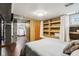 Basement bedroom with built-in shelving, a small window, and a bed at 944 N Harbison Ave, Indianapolis, IN 46219