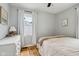 Cozy bedroom with hardwood floors, a large window, and a ceiling fan at 944 N Harbison Ave, Indianapolis, IN 46219