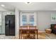 Cozy dining room with wood table and chairs, natural light, and easy access to the adjacent kitchen at 944 N Harbison Ave, Indianapolis, IN 46219