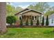 Charming home boasting an orange front door, manicured lawn, and fresh landscaping at 944 N Harbison Ave, Indianapolis, IN 46219