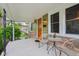 Charming porch with seating, an orange door, and stylish accents for relaxing outdoors at 944 N Harbison Ave, Indianapolis, IN 46219