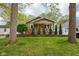 Inviting single-Gathering home featuring mature trees, a manicured lawn, and lovely landscaping at 944 N Harbison Ave, Indianapolis, IN 46219