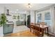 Updated kitchen with stainless steel appliances, green cabinets, and a dining area filled with natural light at 944 N Harbison Ave, Indianapolis, IN 46219