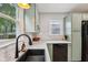 Kitchen area with black sink, stainless appliances, light countertops and cabinetry at 944 N Harbison Ave, Indianapolis, IN 46219