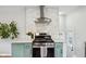 A well-lit kitchen showcasing a stainless steel range and white tile backsplash at 944 N Harbison Ave, Indianapolis, IN 46219