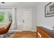 Bright living room featuring hardwood floors, a classic door, and an inviting aesthetic at 944 N Harbison Ave, Indianapolis, IN 46219