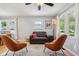 Cozy living room with hardwood floors, matching chairs, and an area rug, bathed in natural light at 944 N Harbison Ave, Indianapolis, IN 46219