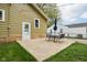 A concrete patio with table, chairs, and umbrella in the backyard offers a nice outdoor space at 944 N Harbison Ave, Indianapolis, IN 46219