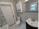 A modern bathroom featuring a toilet, vanity with sink, and stylish design at 1009 Chestnut St, Anderson, IN 46012