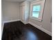 An empty bedroom with hardwood floors and a closet with windows at 1009 Chestnut St, Anderson, IN 46012