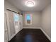 An empty bedroom with a rustic barn door leading to the bathroom at 1009 Chestnut St, Anderson, IN 46012