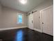 A serene empty bedroom featuring hardwood floors and plenty of natural light at 1009 Chestnut St, Anderson, IN 46012