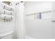 Bright bathroom features a toilet and shower with white subway tile, a shower curtain, and built-in toiletry shelves at 1009 Harrison St, Indianapolis, IN 46202